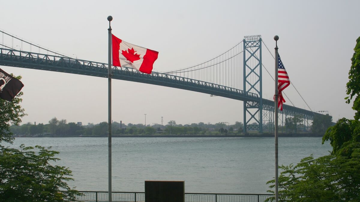 Canadian and American flags overlooking the Ambassador Bridge border crossing in Windsor, Ontario