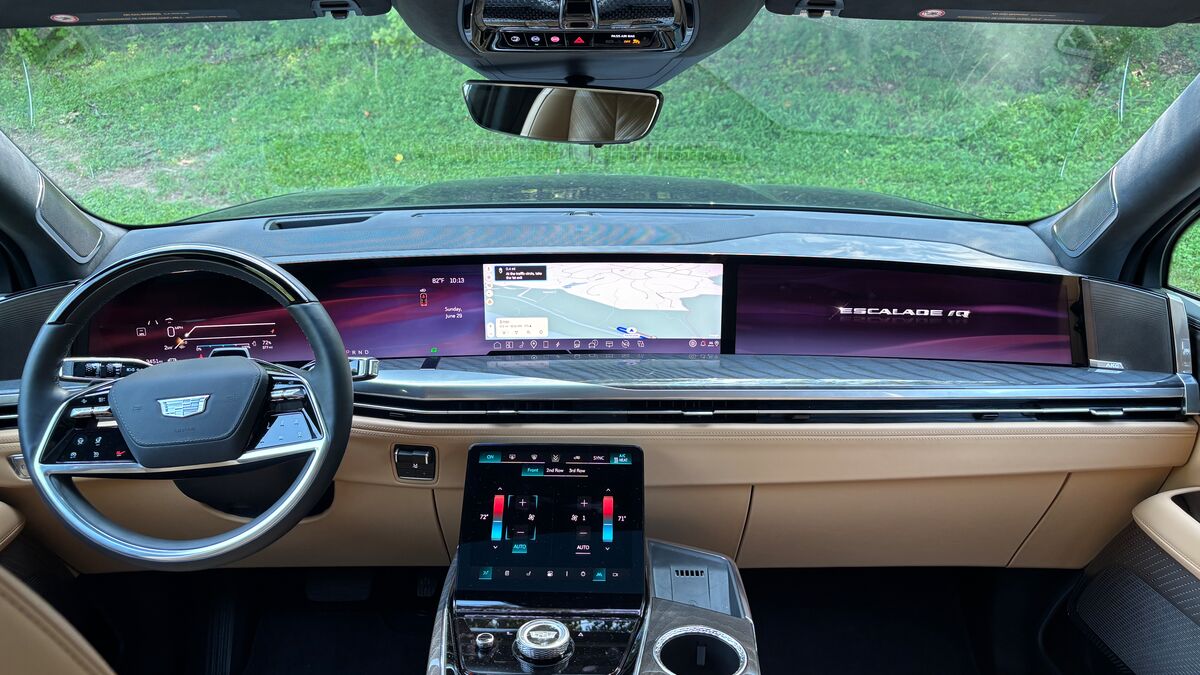 The interior of the 2025 Cadillac Escalade IQ with its three-part screen setup