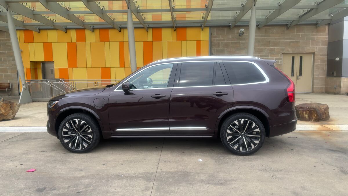 The 2025 Volvo XC90 T8 AWD Ultra in Mulberry Red seen in profile