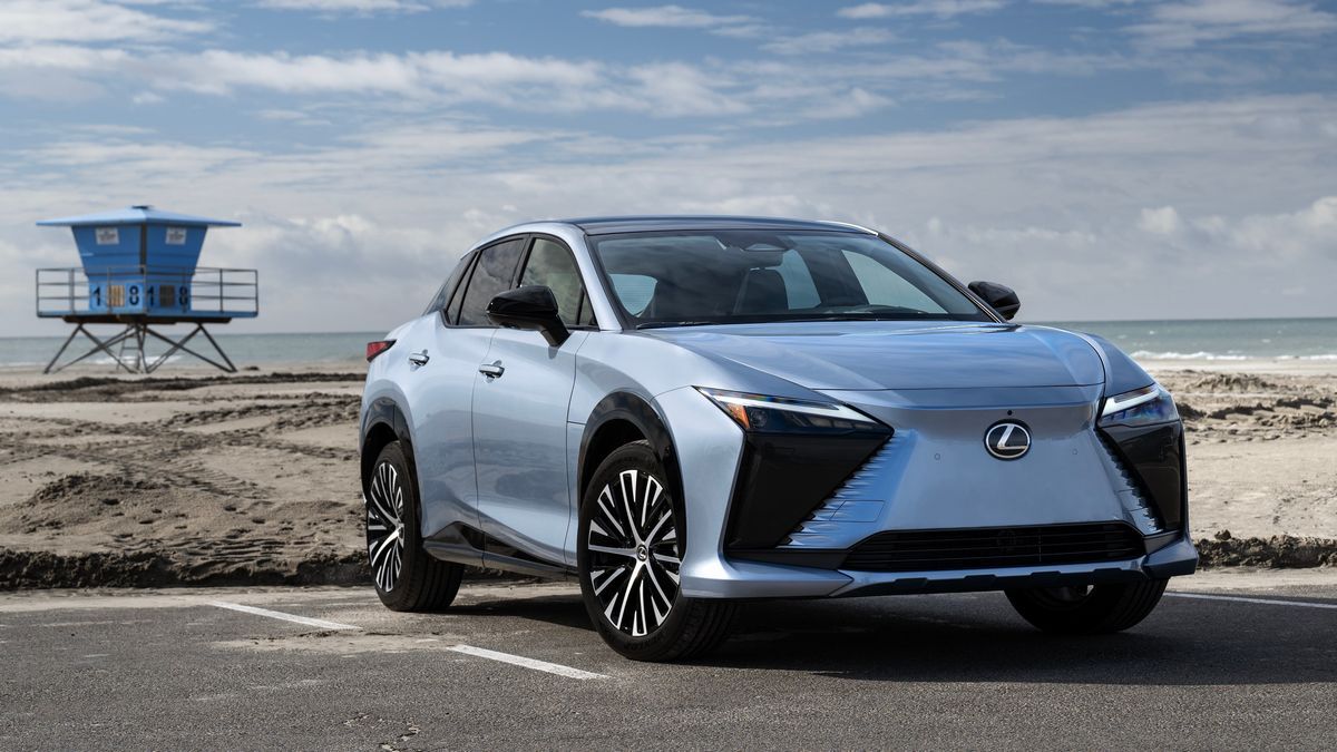 The 2025 Lexus RZ in blue seen from a front quarter angle on a beach