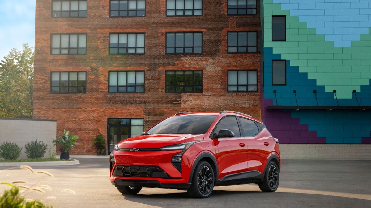 The 2027 Chevrolet Bolt in orange seen from a front quarter angle