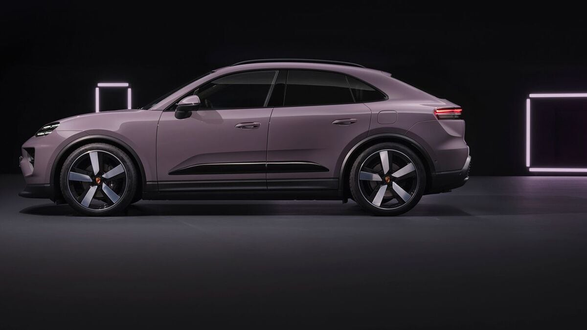 The 2025 Porsche Macan Electric SUV in purple seen in profile