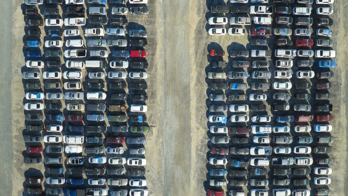 An overhead photo of an auction lot showing hundreds of used cars lined up for sale