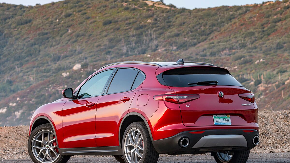 The 2018 Alfa Romeo Stelvio in red seen from a rear quarter angle