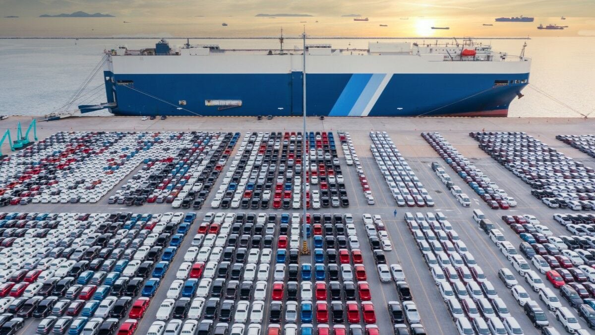 A roll-on/roll-off car carrier ship in port with thousands of cars