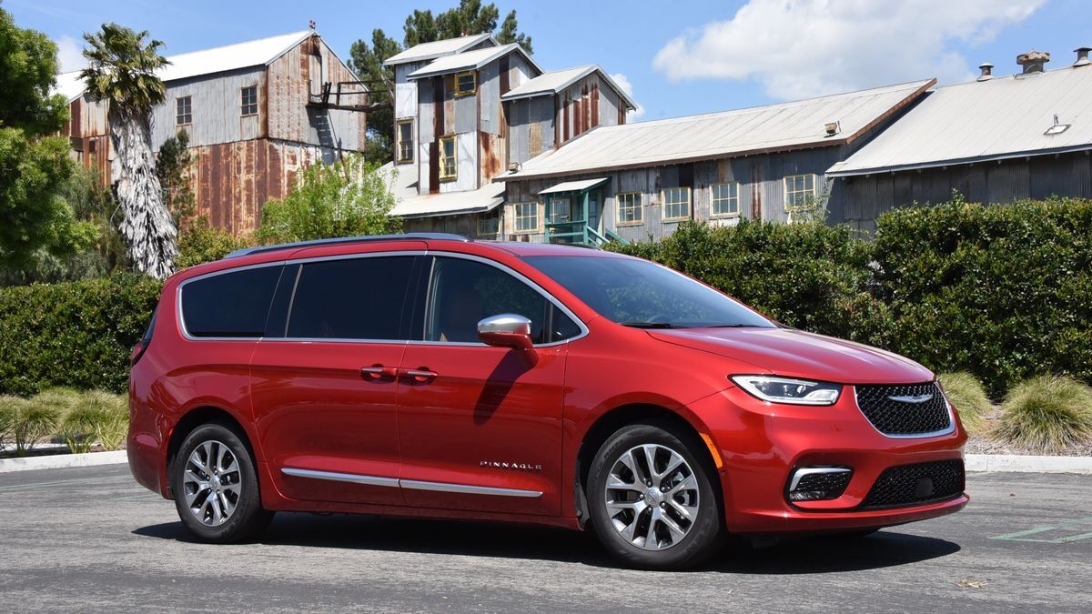 The 2025 Chrysler Pacifica minivan in red seen from a front quarter angle