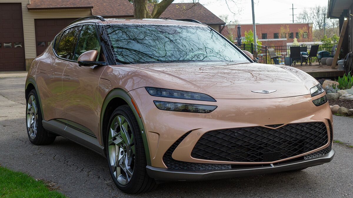 The 2024 Genesis GV60 in copper seen from a front quarter angle