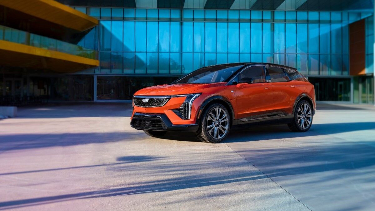 The 2025 Cadillac Optiq in orange seen from a front quarter angle