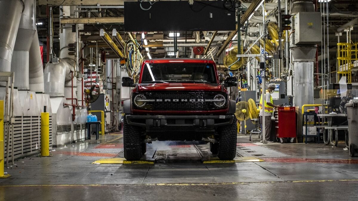 A 2021 Ford Bronco in red rolls through the assembly process