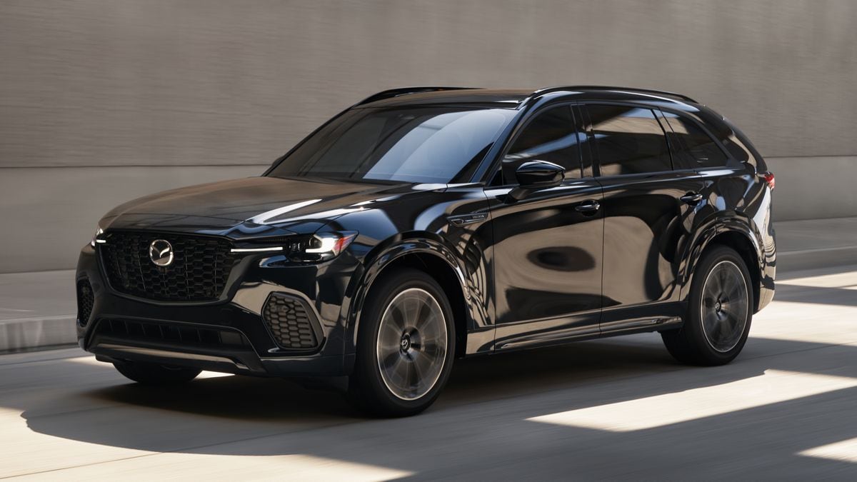 2025 Mazda CX-70 PHEV driving on a high-walled freeway.