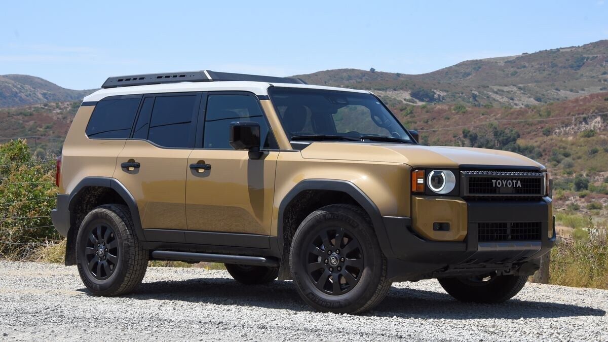 The 2025 Toyota Land Cruiser in beige with a white roof seen from a front quarter angle
