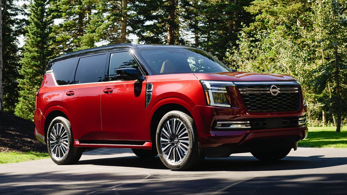 2025 Nissan Armada in red by a forest.