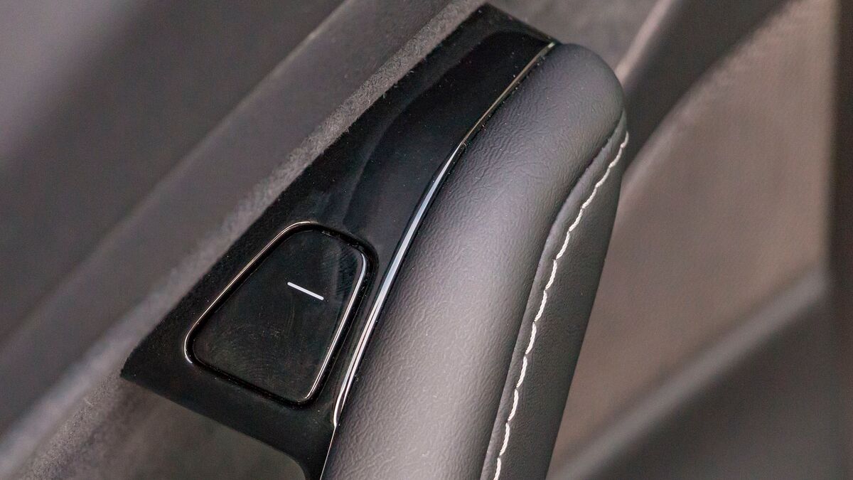 The interior door button in a 2018 Tesla Model 3