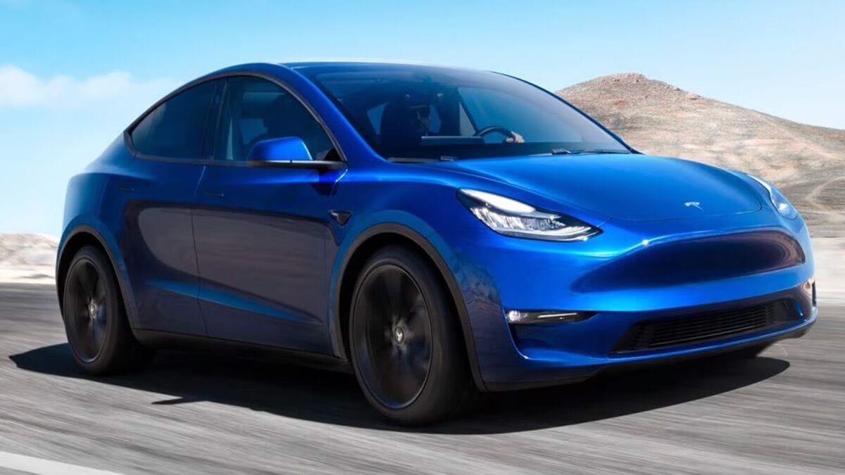 2021 Tesla model Y driving on the road.