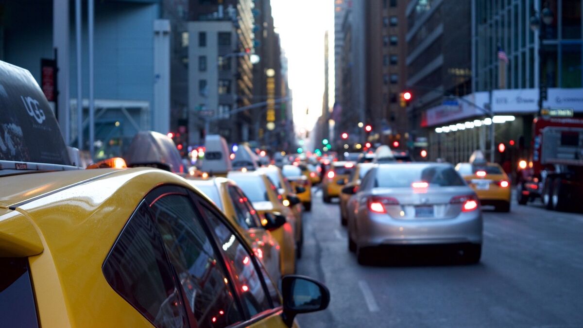 Cars braking in New York City traffic showing their rear brake lights