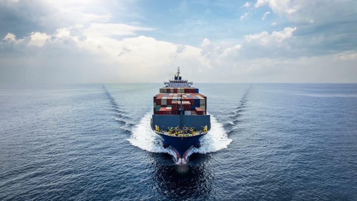 A stock photograph of a cargo ship crossing an ocean